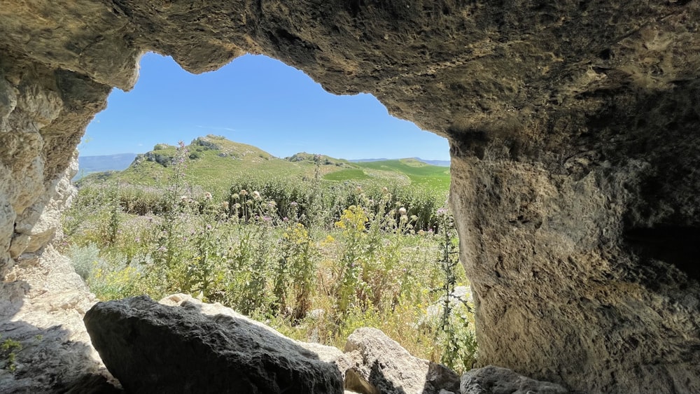 a view from inside a cave of a mountain