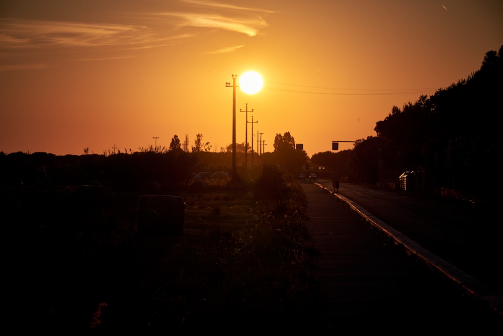 the sun is setting over a city street