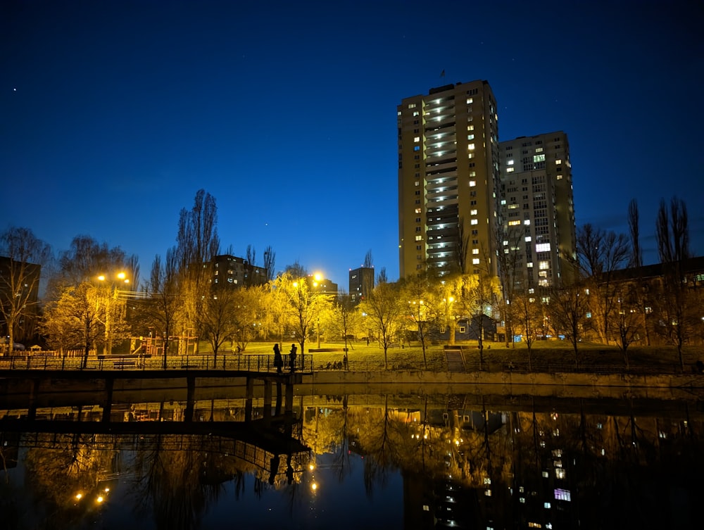 a body of water in front of tall buildings