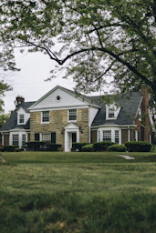 a large house with a clock on the front of it