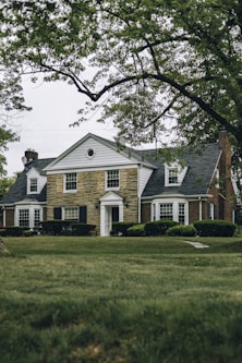 a large house with a clock on the front of it