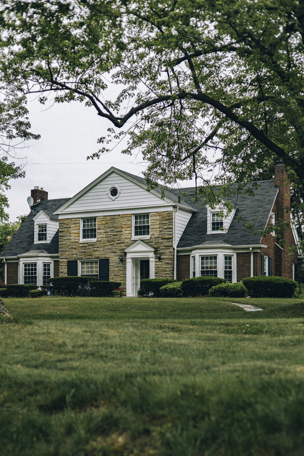 a large house with a clock on the front of it