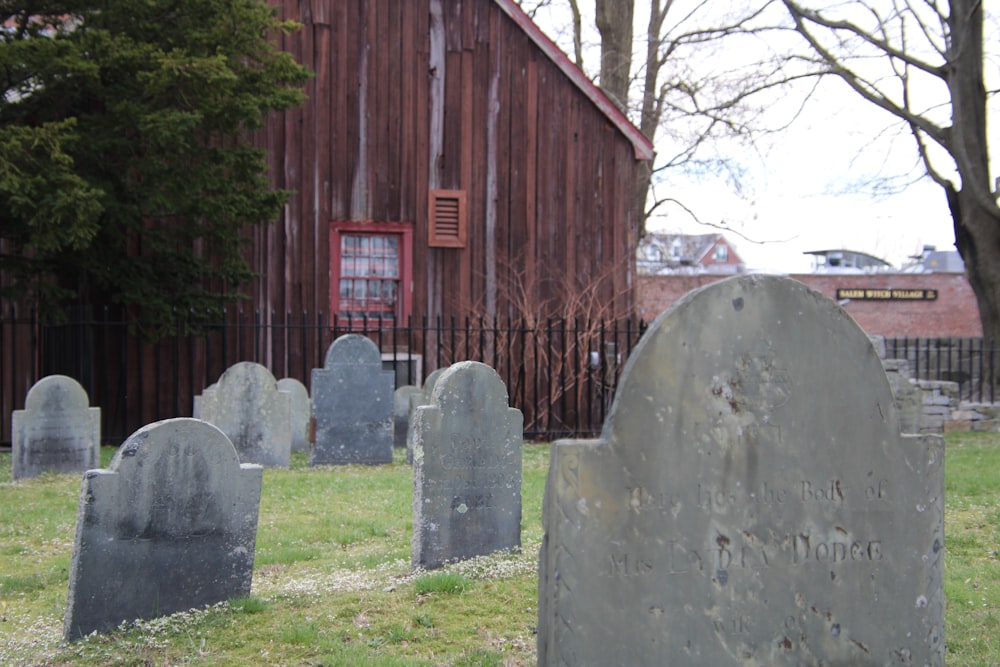 a cemetery with a red barn in the background