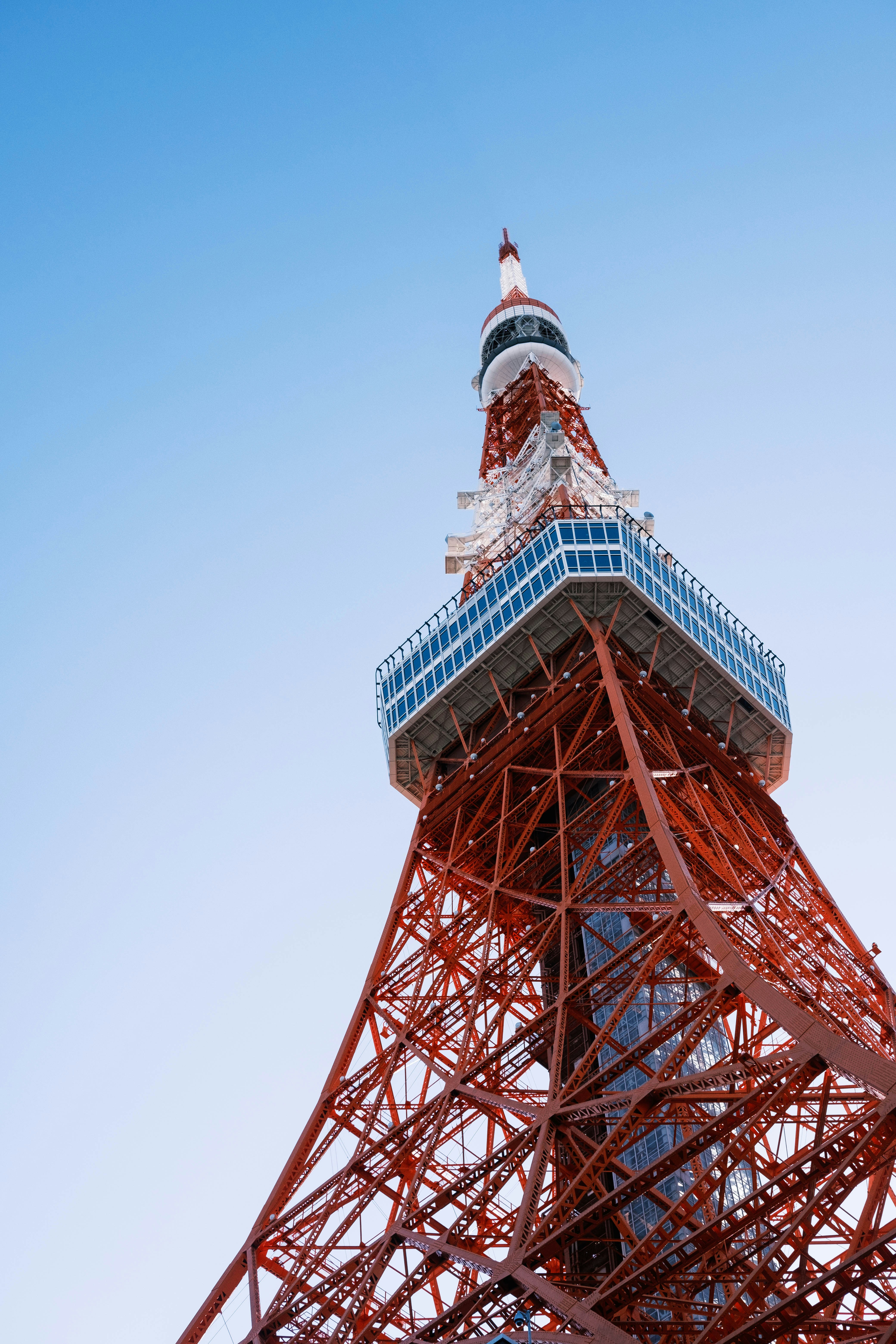 the top of the eiffel tower against a blue sky