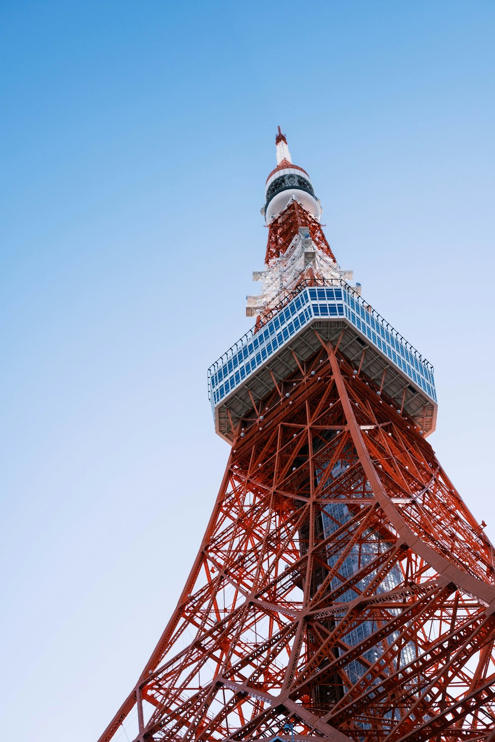 the top of the eiffel tower against a blue sky