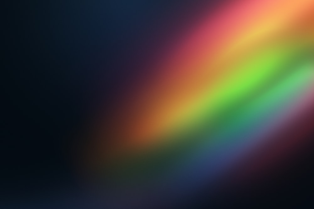 a blurry image of a rainbow colored object