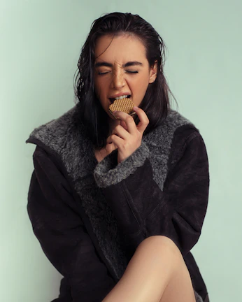 A joyful person savoring a bite, eyes closed, immersed in the taste experience