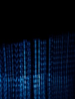 Abstract tech background blending black and navy blue with digital code elements.