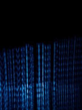 Abstract neon blue data streams flowing over a dark navy background, symbolizing seamless AI connections.