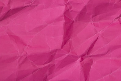 a close up of a pink paper texture