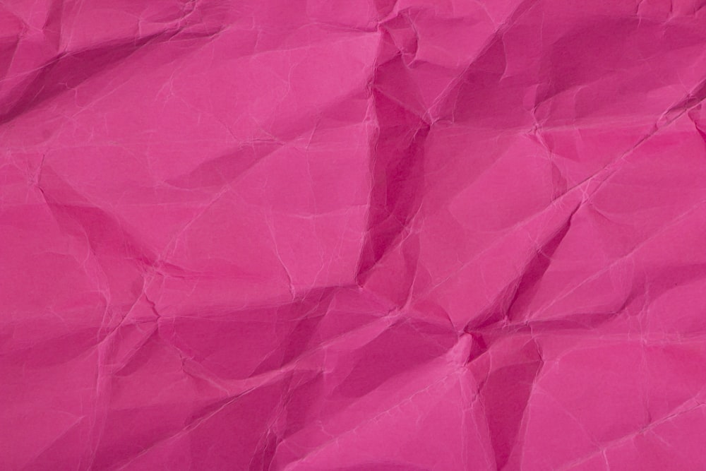 a close up of a pink paper texture