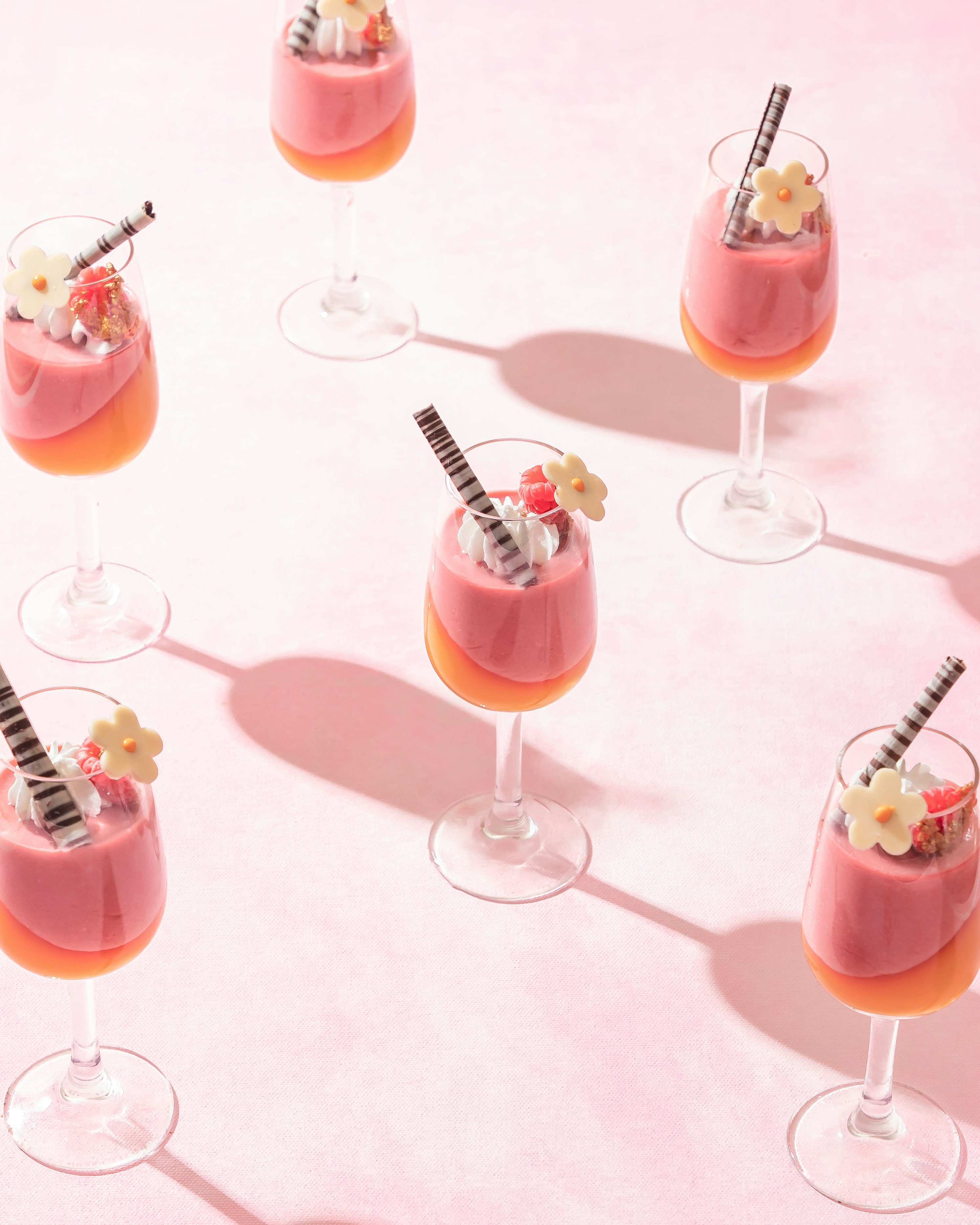 a table topped with glasses filled with different types of drinks