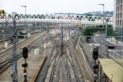 a view of a train station with a bridge in the background