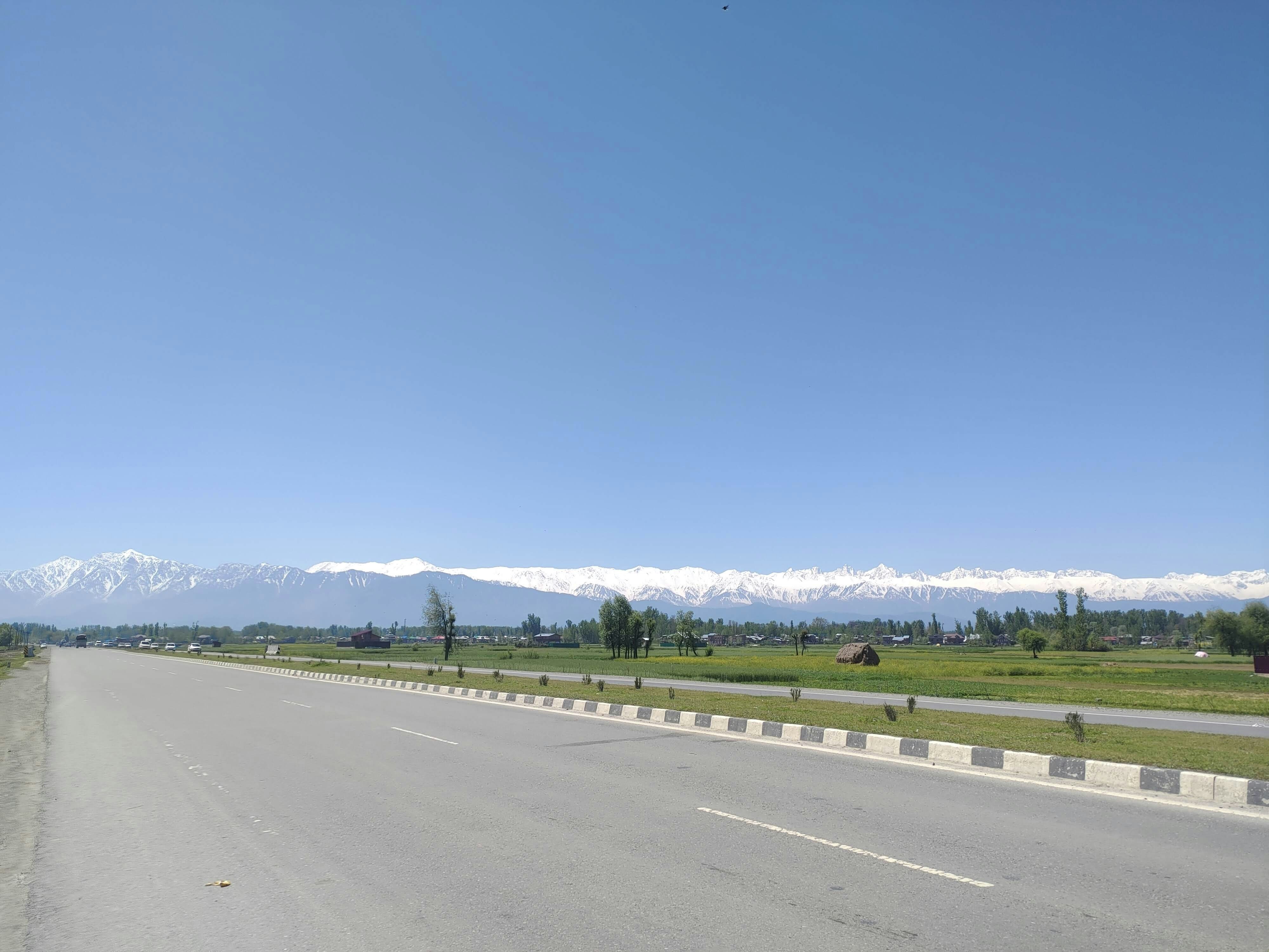 a road with a mountain range in the background