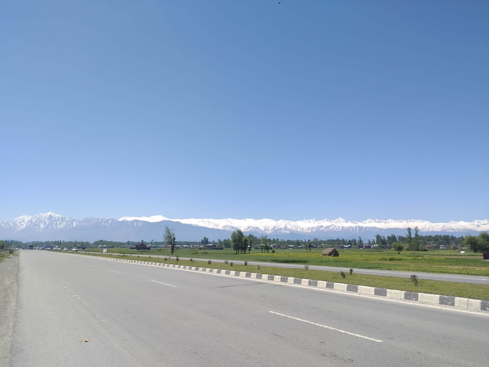 a road with a mountain range in the background