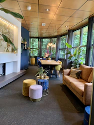 Cozy dining area featuring warm wooden textures and soft green lighting reflecting the Amazonian modern style.