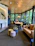 A cozy dining room featuring a solid plywood dining table with warm natural wood tones and modern chairs.