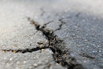 a crack in the asphalt of a road