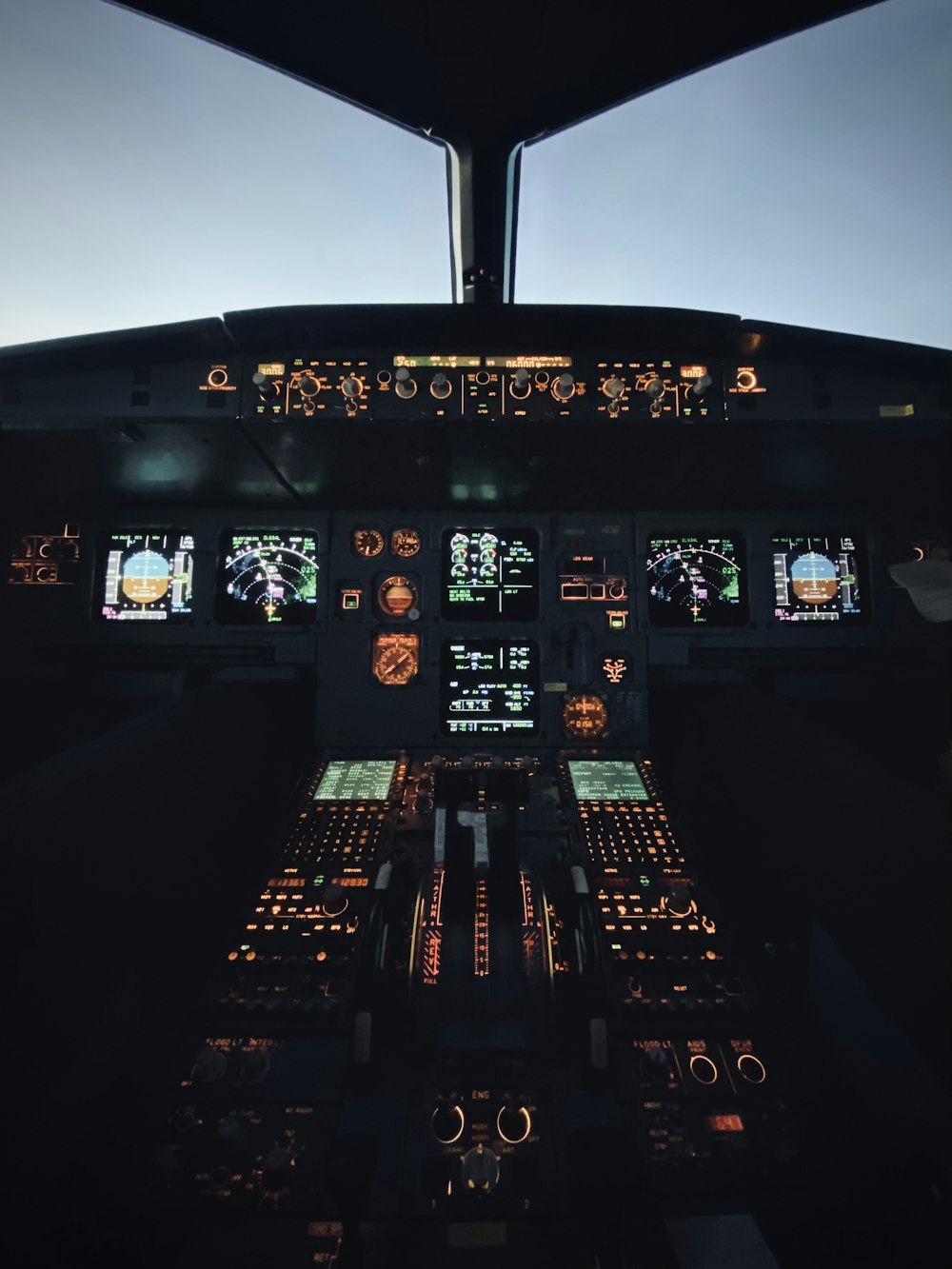 a view of the cockpit of an airplane at night