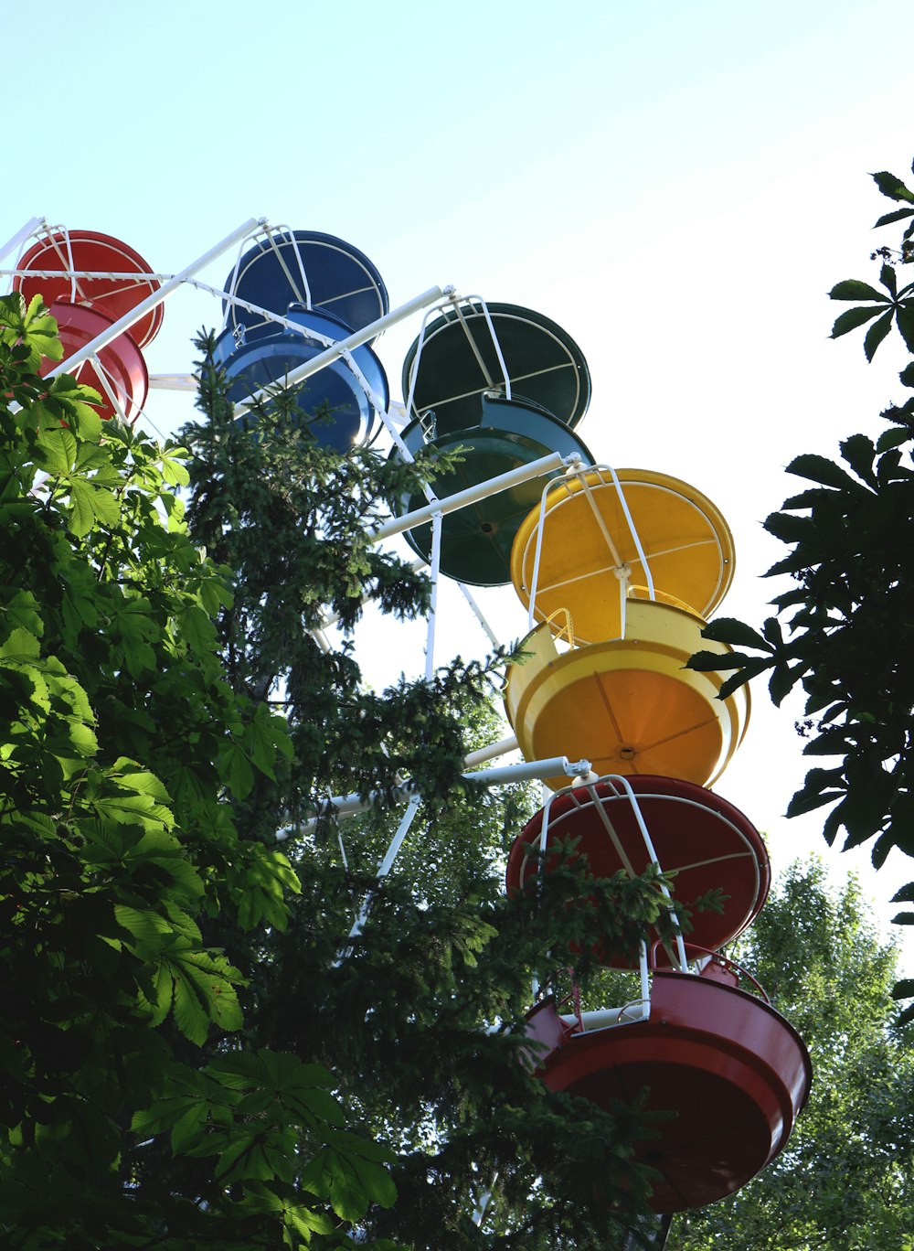 a bunch of buckets hanging from a tree