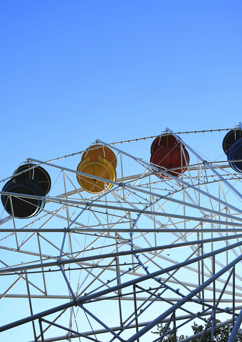 a row of colorful balls sitting on top of a metal structure