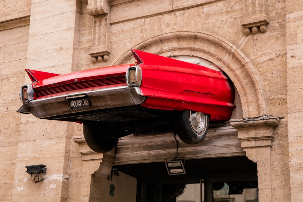 a red car sitting on top of a building