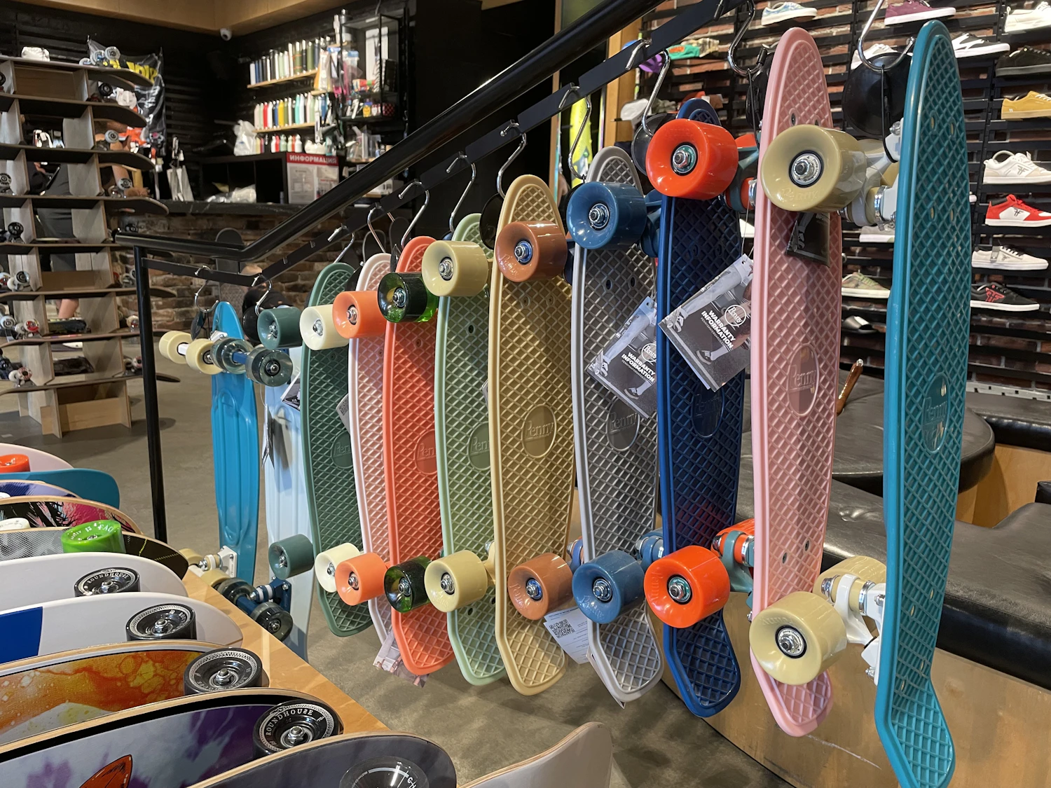 Cruiser boards lined up in a rack by the shop window