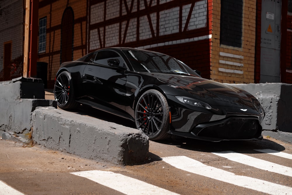 a black sports car parked in front of a building