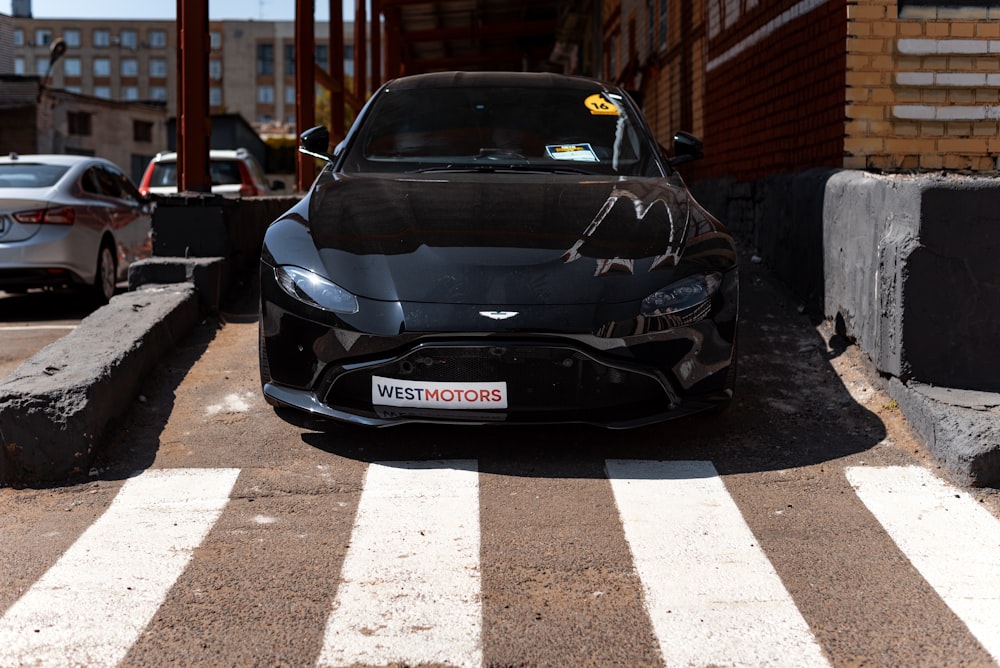 a black sports car parked in a parking lot