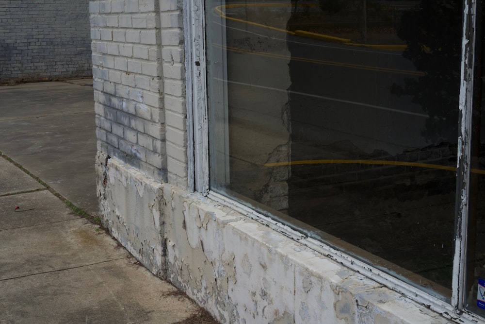 a cat sitting in the window of a building