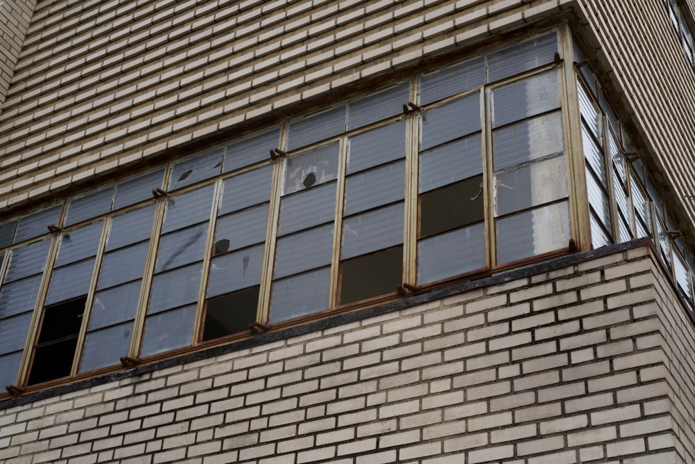 a brick building with broken windows and bars