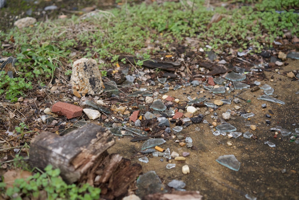 a pile of broken glass sitting on top of a dirt road