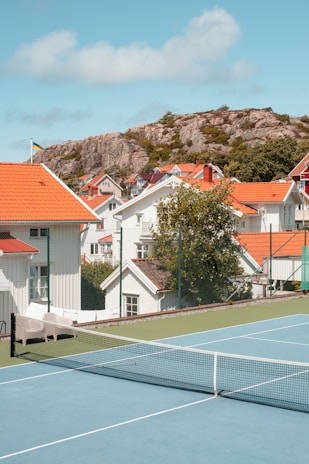 A vibrant tennis court with players in action during a sunny day.