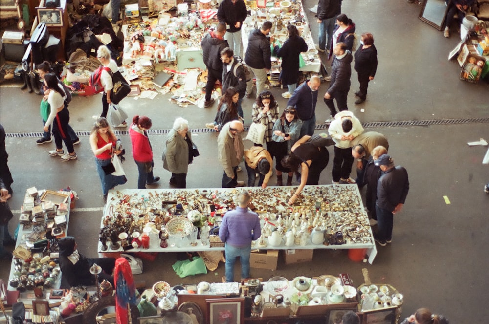 a crowd of people standing around a market