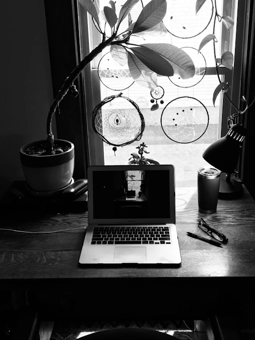 A serene workspace with ancient astrology charts, a palmistry hand model, and a softly glowing lamp.