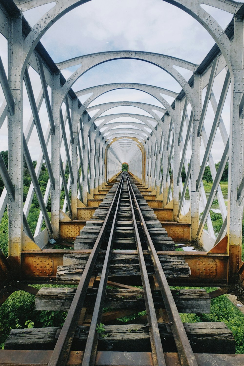 a view of a train track from the top of a bridge