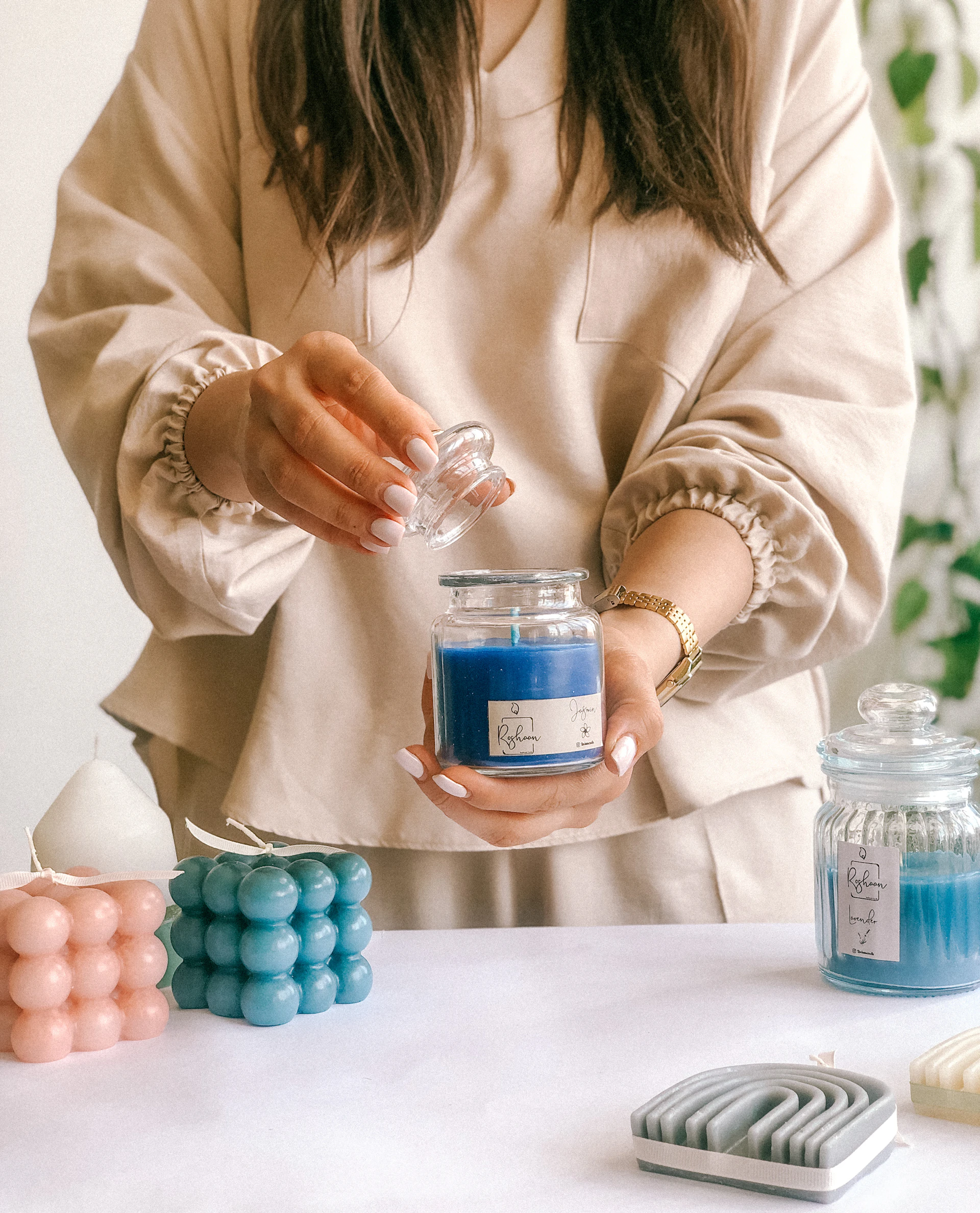 a woman holding a jar of blue liquid