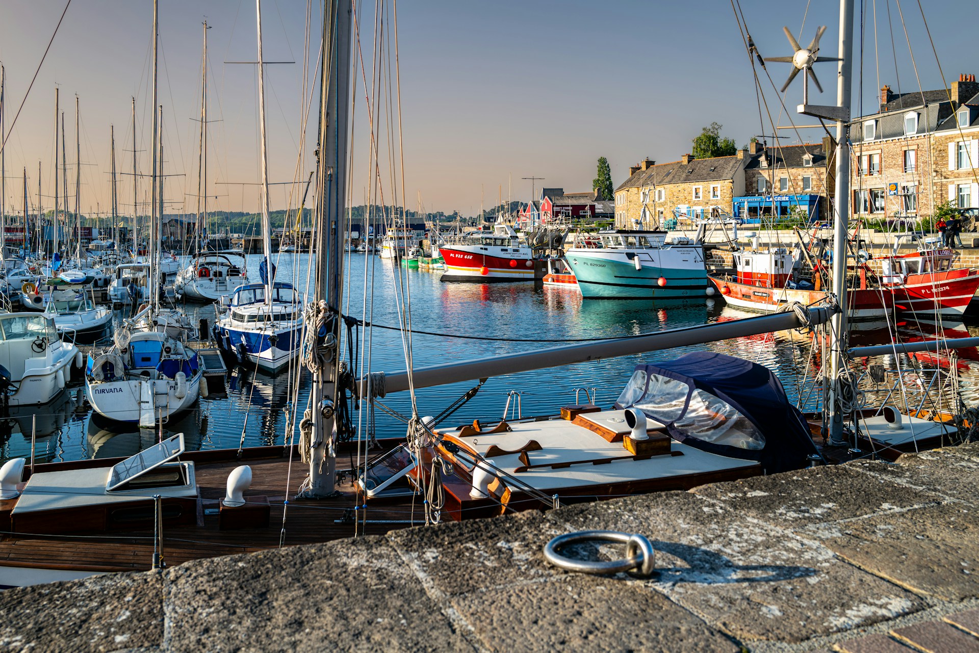 a harbor filled with lots of boats on top of water