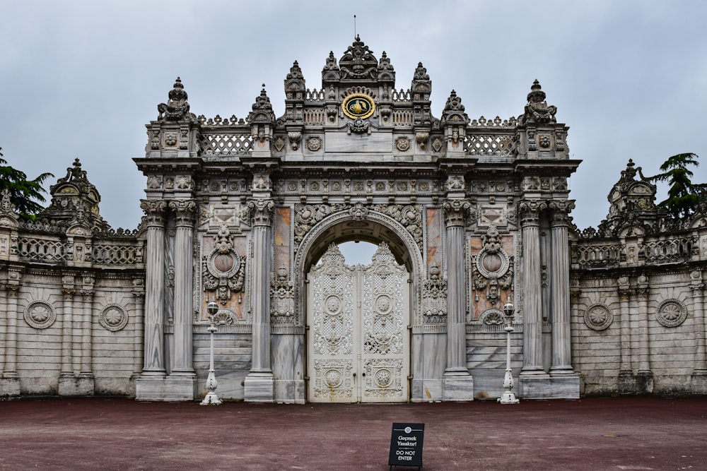 a stone gate with a clock on top of it