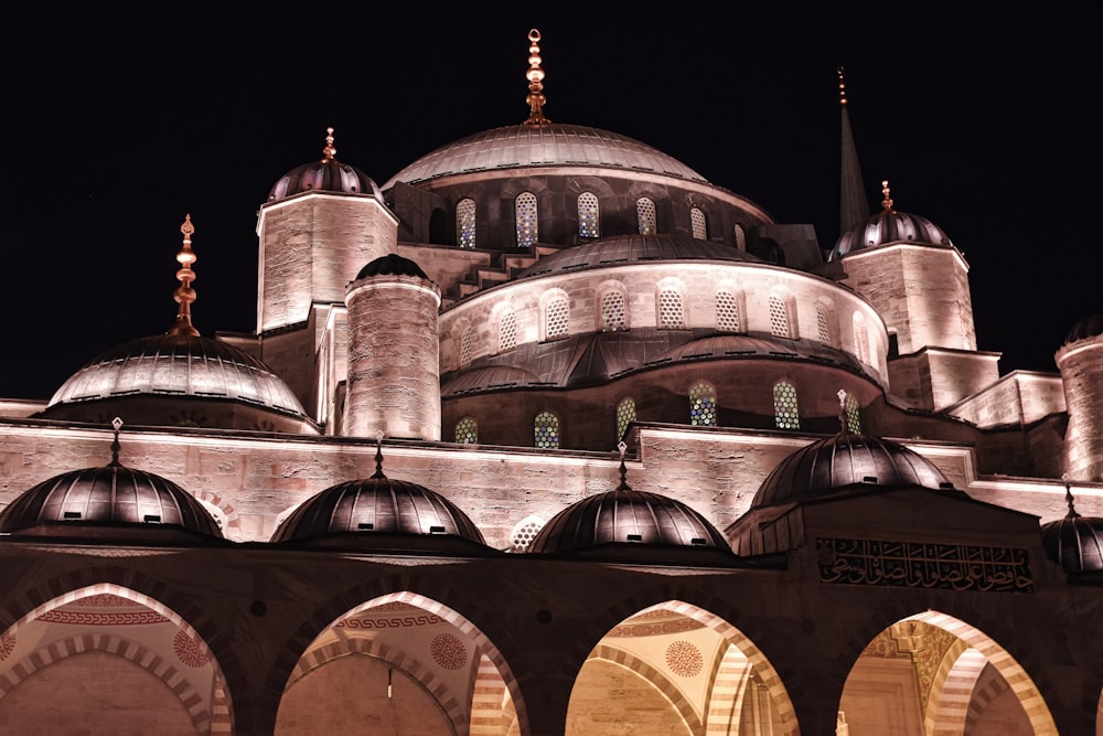 a large building lit up at night with lights on it