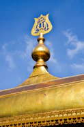 A technician polishing the golden finial (alem) atop a mosque minaret.