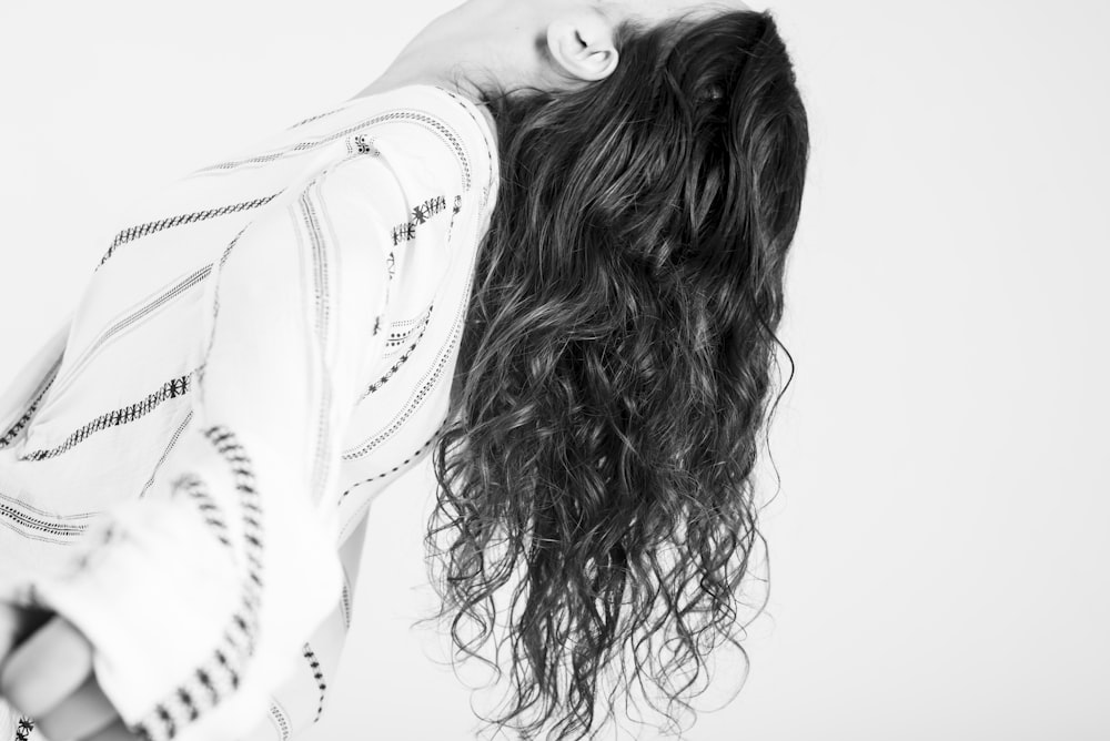 a black and white photo of a woman with long hair