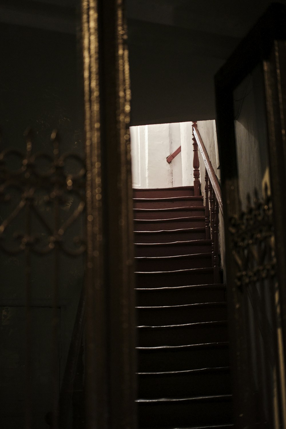 a stair case with a clock on the wall