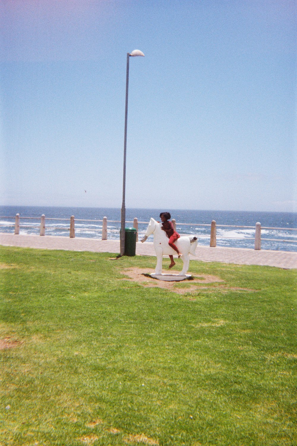 a statue of a woman riding a white horse