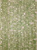 An aerial view of a neatly organized agricultural field with parallel rows of green crops planted in earthy, light-colored soil. The alignment and uniformity of the rows create a visually striking pattern.
