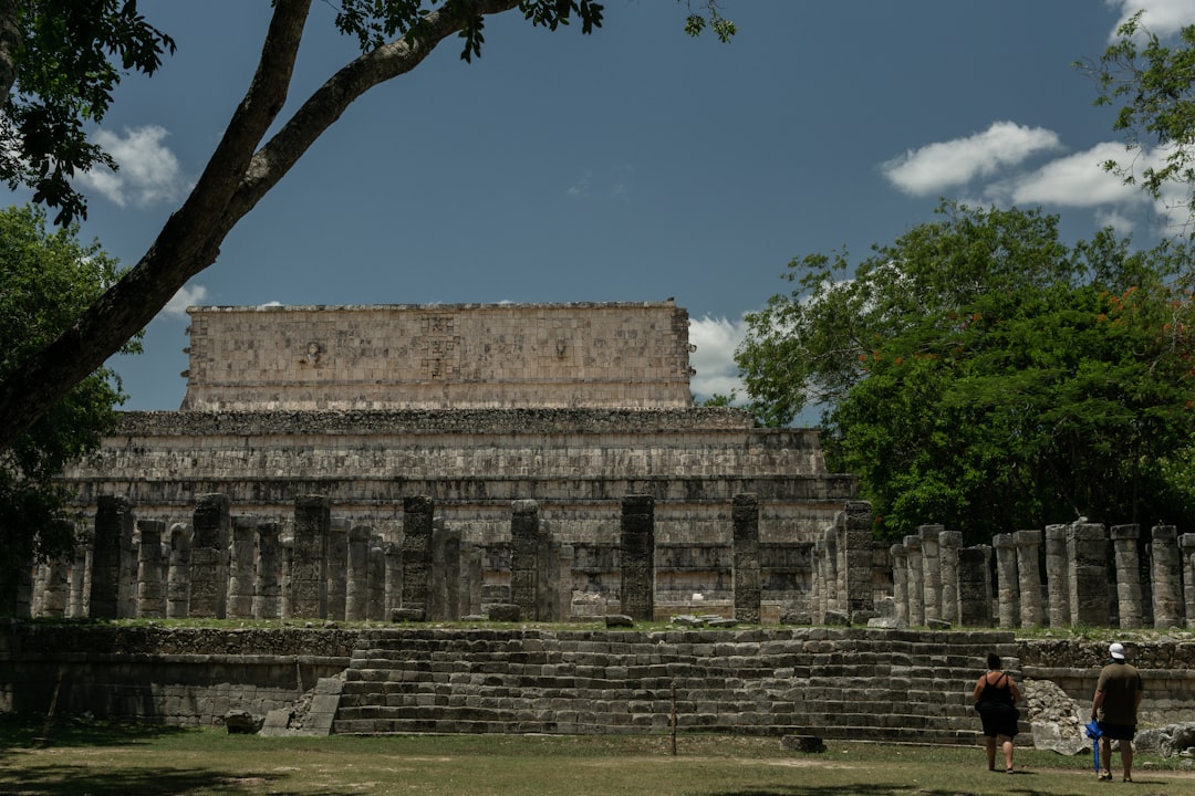 a group of people standing in front of a building,