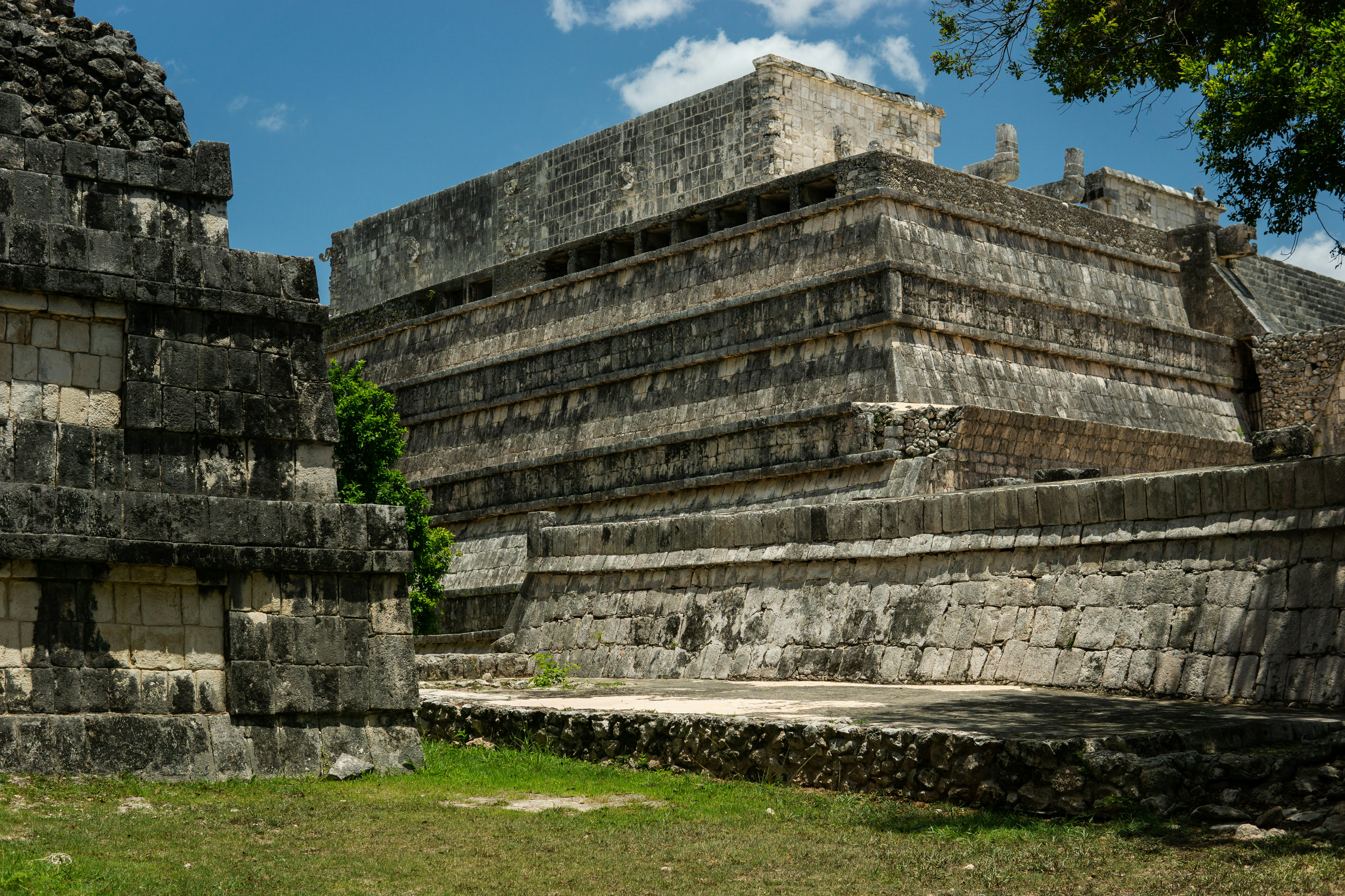 a group of stone structures sitting on top of a lush green field, 
