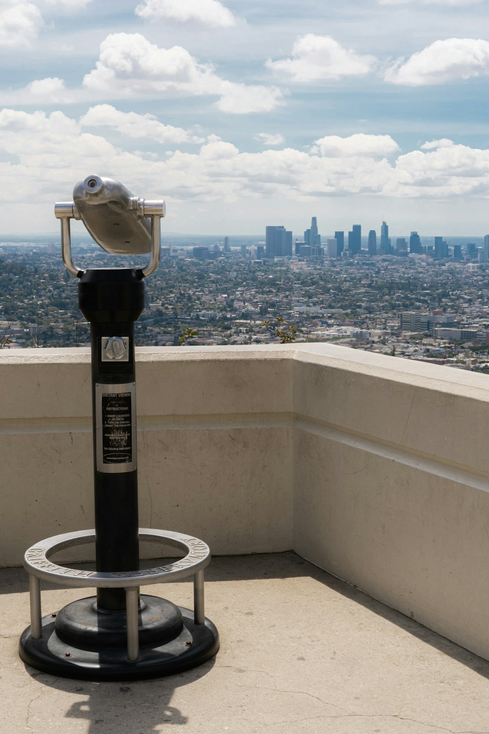 a telescope on top of a building overlooking a city