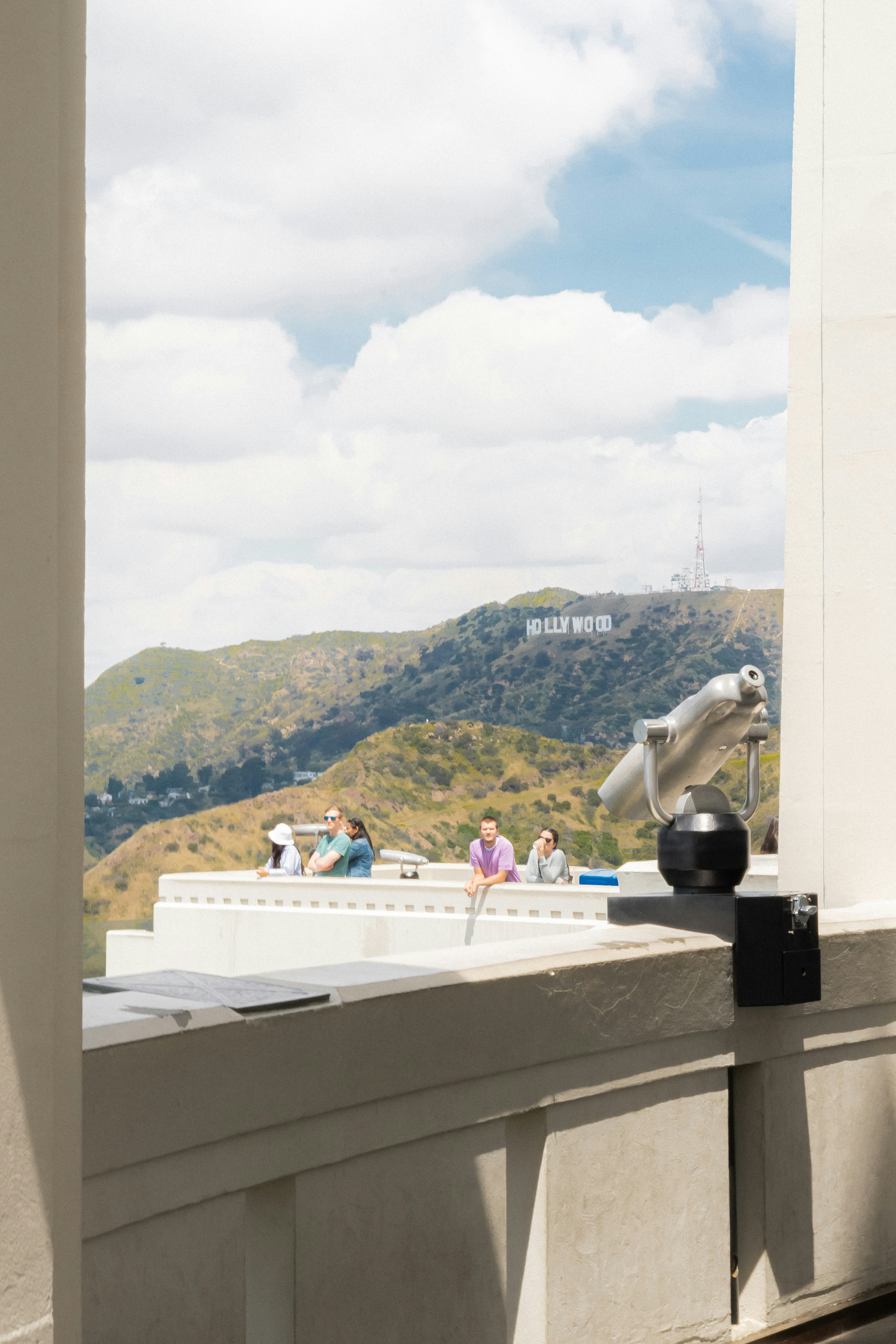 a bird sitting on the ledge of a building