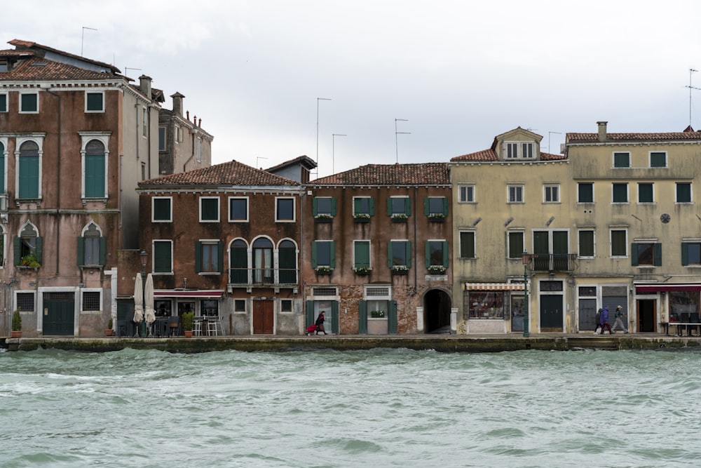 a row of buildings next to a body of water